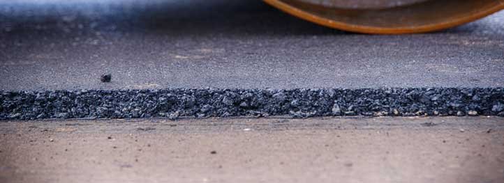 Picture of asphalt overlay being compressed by a roller. Picture taken in Fort Lauderdale, Florida