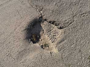 Pothole in asphalt that needs to be filled