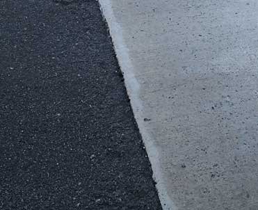 Picture of asphalt pavement against concrete pavement